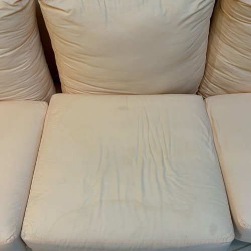 Three-seater fabric sofa used, light pink-peach color with side cushions