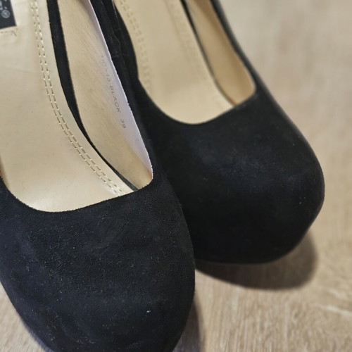 Black suede high heels with gold zipper