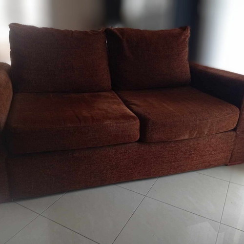 Two-seater sofa used, warm brown color, removable cushion covers