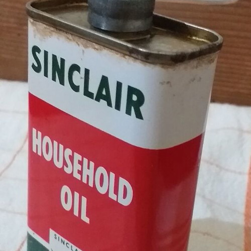 Set of 4 used oil collectors with iron, tin, and plastic