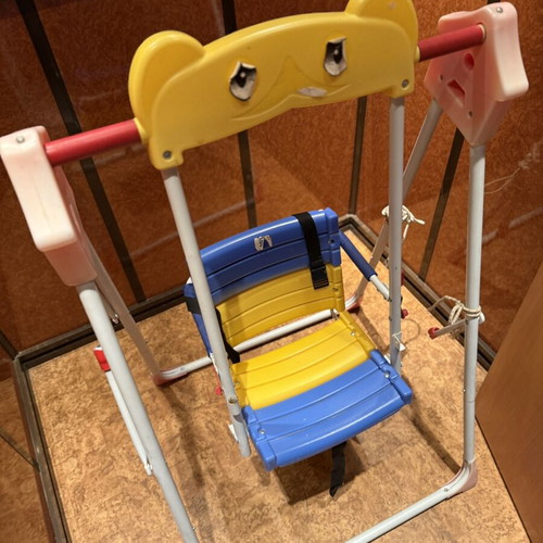 Children's swing with seat and safety straps used