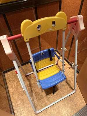 Children's swing with seat and safety straps used