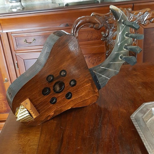 African string instrument used, made of animal horn and wood