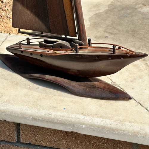 Handmade wooden sailboat used on base, modern nautical decoration