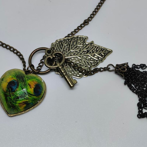 Vintage necklace with antique bronze elements and peacock feather heart pendant like new