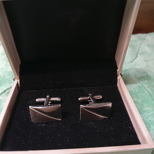 Silver cufflinks in book-style case