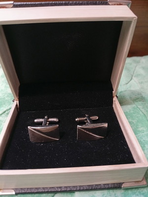 Silver cufflinks in book-style case