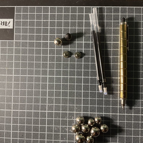 Gold Fidget Pen used with magnetic parts and two ink refills