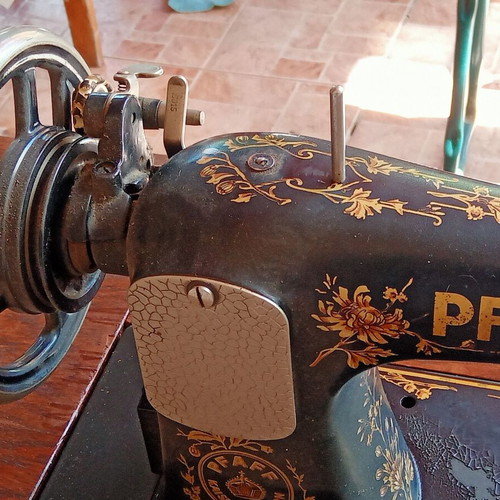 Antique sewing machine used with furniture and accessories