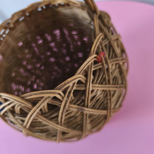 Handmade woven basket used with handle and decorative beads