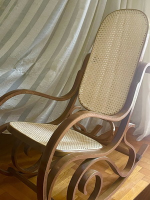 Wooden rocking chair with cane seat, walnut finish