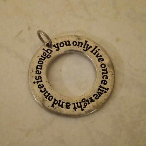 Silver pendant used with engraved quote