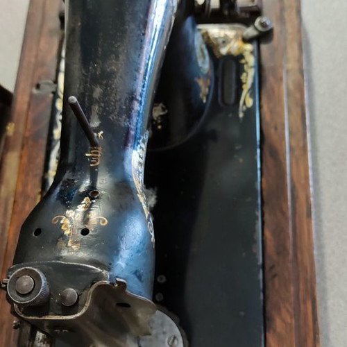 Singer sewing machine used with original wooden cover and key