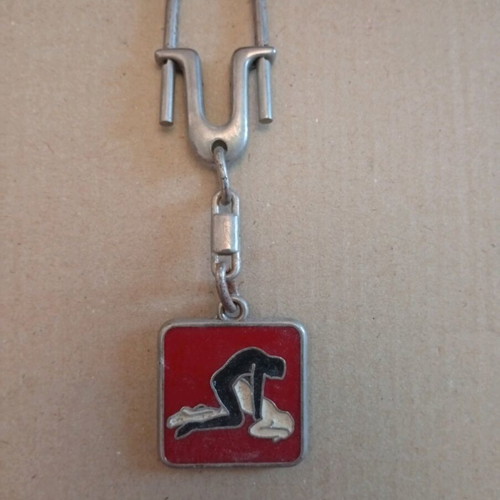 Vintage keychain like new with schematic sexual position design, red