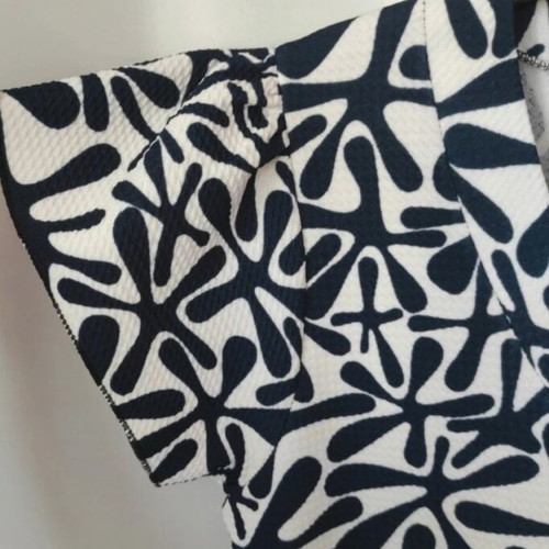 D.X. Oscar mini dress black and white with ruffles and satin detail, like new