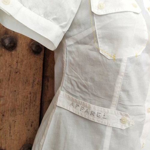 White short sleeve utility shirt with contrast stitching and waist strap