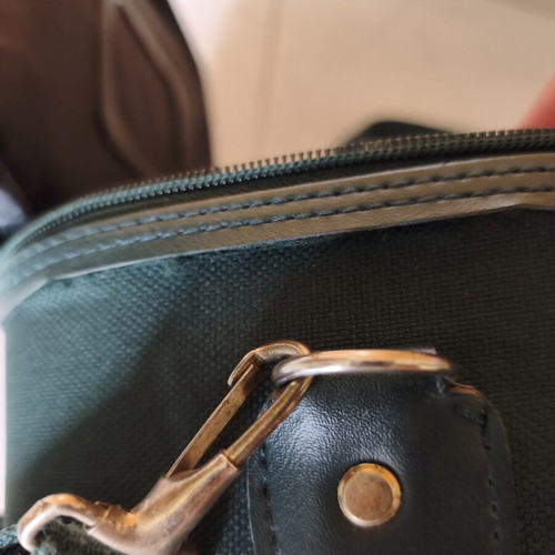 Toiletry bag used, green, fabric defect