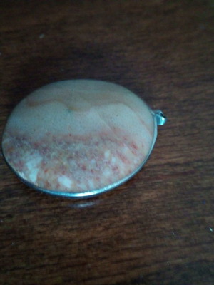 Banded agate pendant in silver base used, oval with curvature