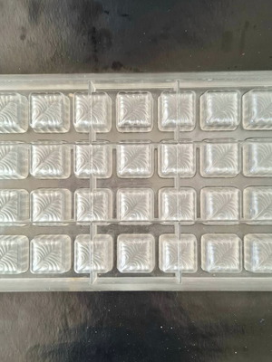 Polycarbonate mold for square chocolates used with feather design