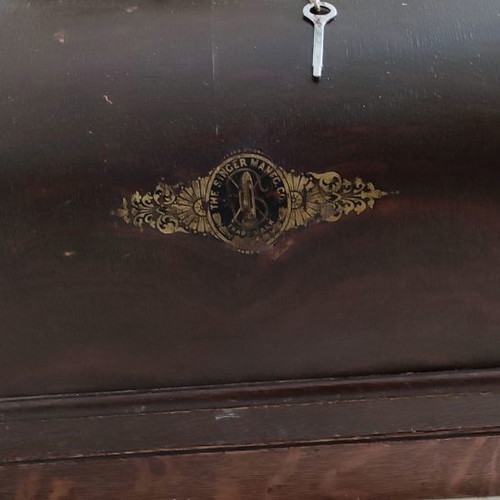 Singer sewing machine used with original wooden cover and key