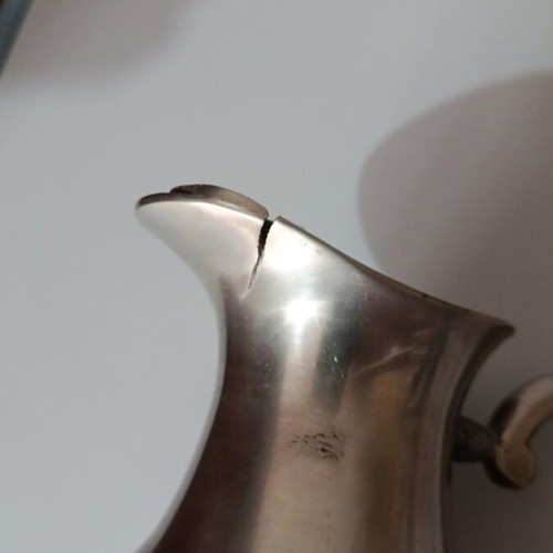 Vintage metal pitcher used with hinged lid and embossed handle