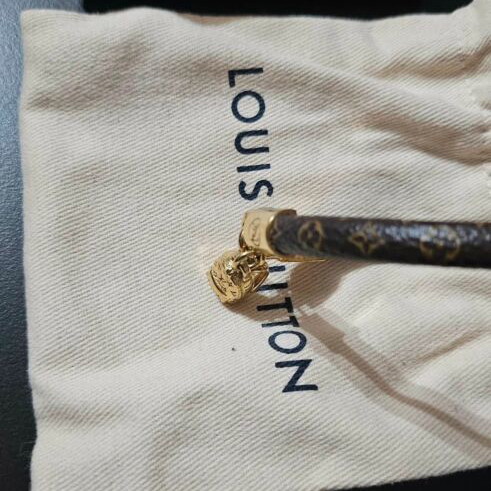 Louis Vuitton leather bracelet with gold plated backpack charm