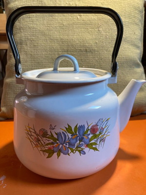 Vintage enamel teapot used with floral design