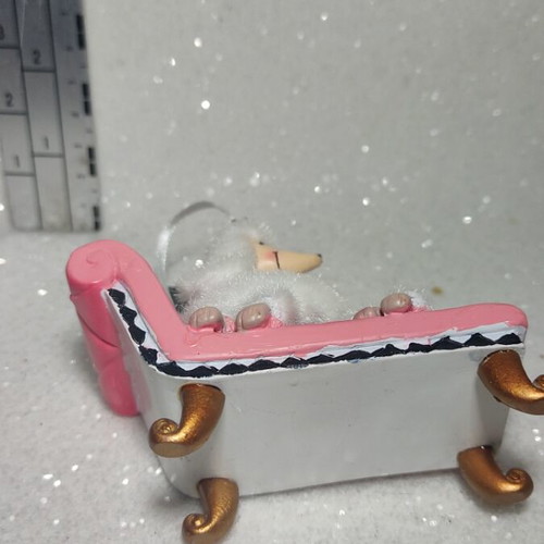 Dog ornament on chaise lounge, hanging decoration