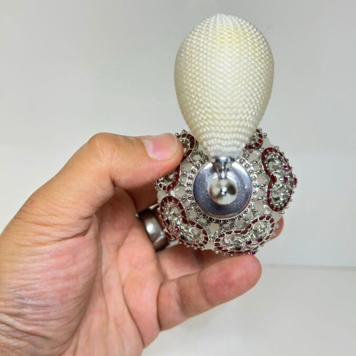 Vintage perfume bottle with pump, decorative hearts and crystals