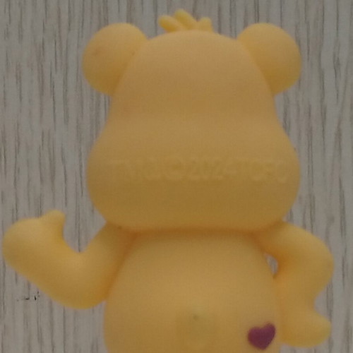 Care Bears Yellow Love-A-Lot Bear figure used with red heart