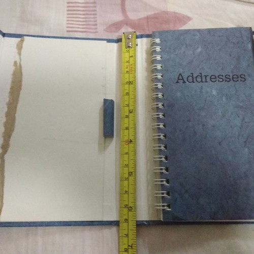 Phone book with magnetic closure and pen holder
