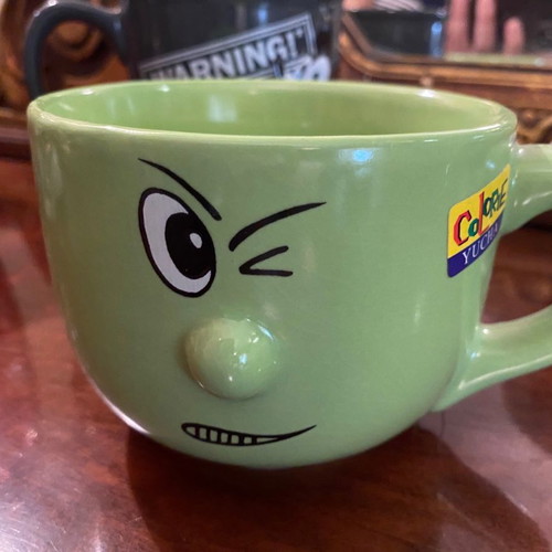 Large mug used with cartoon green handle