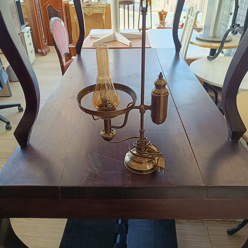 Retro table lamp made of brass used, oil lamp style with amber glass chimney