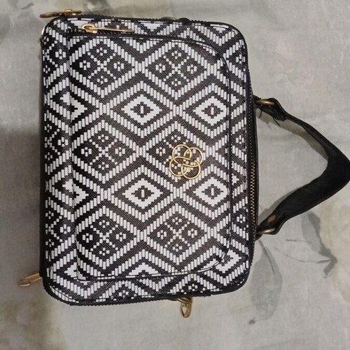 Black and white handbag with dual zipper and spacious interior