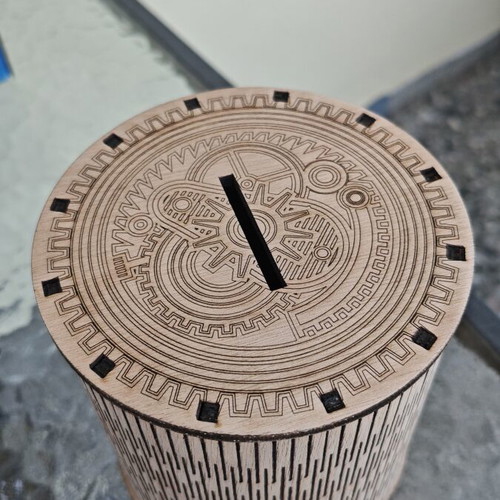 Handmade wooden laser-cut piggy bank with mechanical design