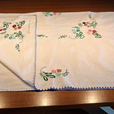 Vintage handmade embroidered tablecloth with flowers and needlework