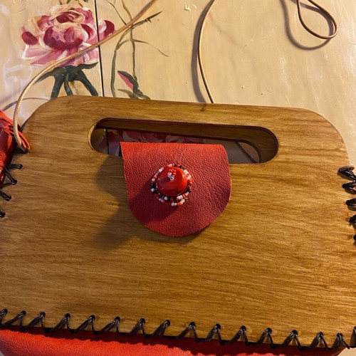 Wooden handmade bag with red leather stitched by hand