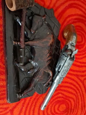 Vintage decorative items used, wooden frame 1951, smoking pipe, metal revolver
