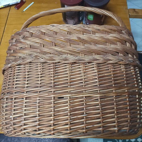 Handmade dark brown wicker basket with high arched handle