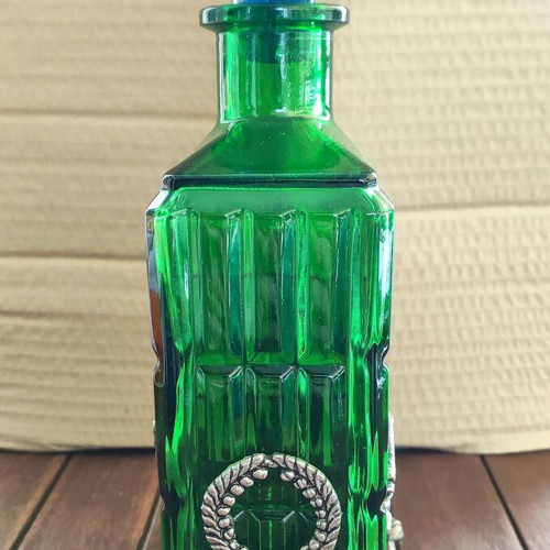 Vintage Italian glass bottle in metal base like new