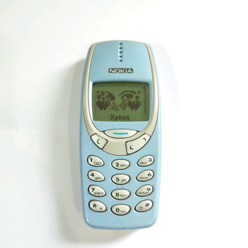 Nokia 3330 phone used with charger and buttons