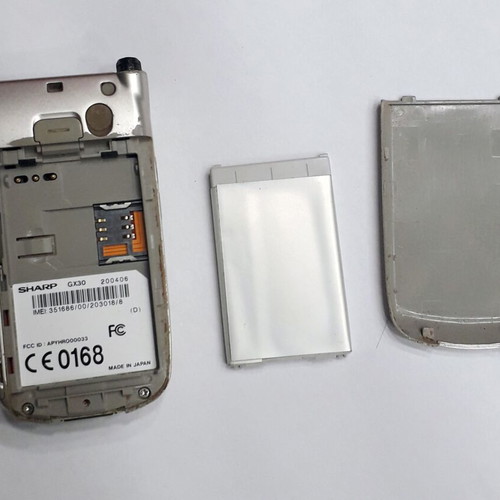 Sharp GX30 mobile phone used, silver, missing antenna part
