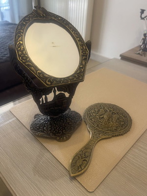 Set of two brass mirrors, table and hand used