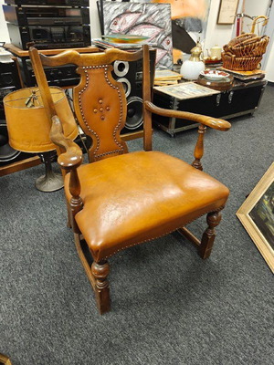Antique chair used with wooden frame and brown leather upholstery