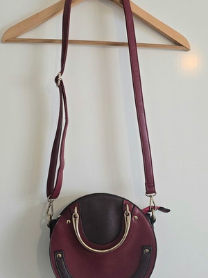 Round red shoulder bag