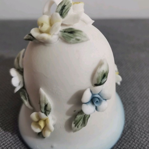 Ceramic bell used with embossed flower designs