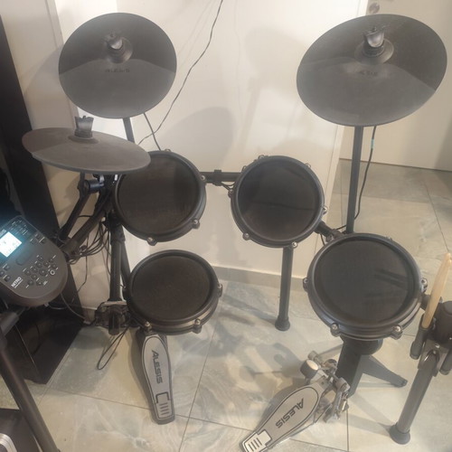 Alesis Nitro Mesh Kit electronic drums with Sony headphones and drumsticks holder
