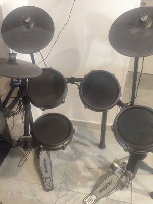 Alesis Nitro Mesh Kit electronic drums with Sony headphones and drumsticks holder