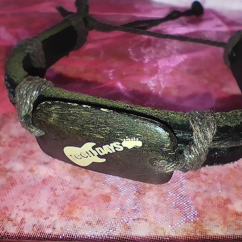 Brown bracelet new with wooden guitar decoration and cord details