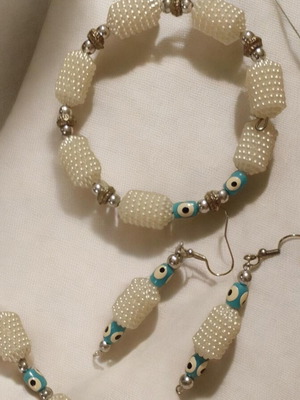 Handmade jewelry set with embossed beads and blue evil eye